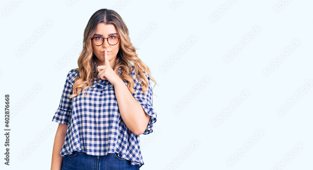 Young caucasian woman wearing casual clothes asking to be quiet with finger on lips. silence and secret concept. Young caucasian woman wearing casual clothes asking to be quiet with finger on lips. silence and secret concept.