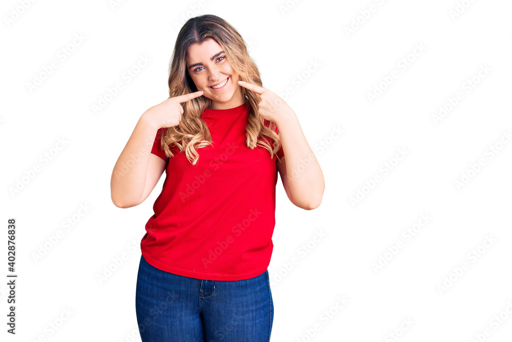 Young caucasian woman wearing casual clothes smiling cheerful showing and pointing with fingers teeth and mouth. dental health concept. Young caucasian woman wearing casual clothes smiling cheerful showing and pointing with fingers teeth and mouth. dental health concept.