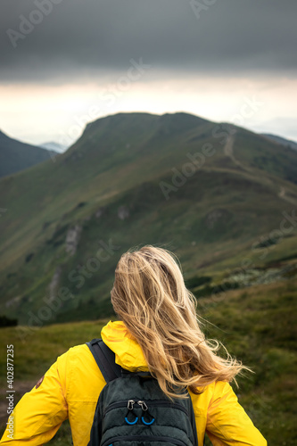 Long way up to hill. Challenge and success. Woman hiking in mountain. Wind in hair © encierro