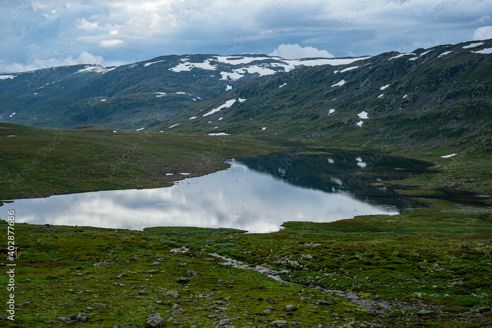 Norwegian landscape with snow fields and clouds