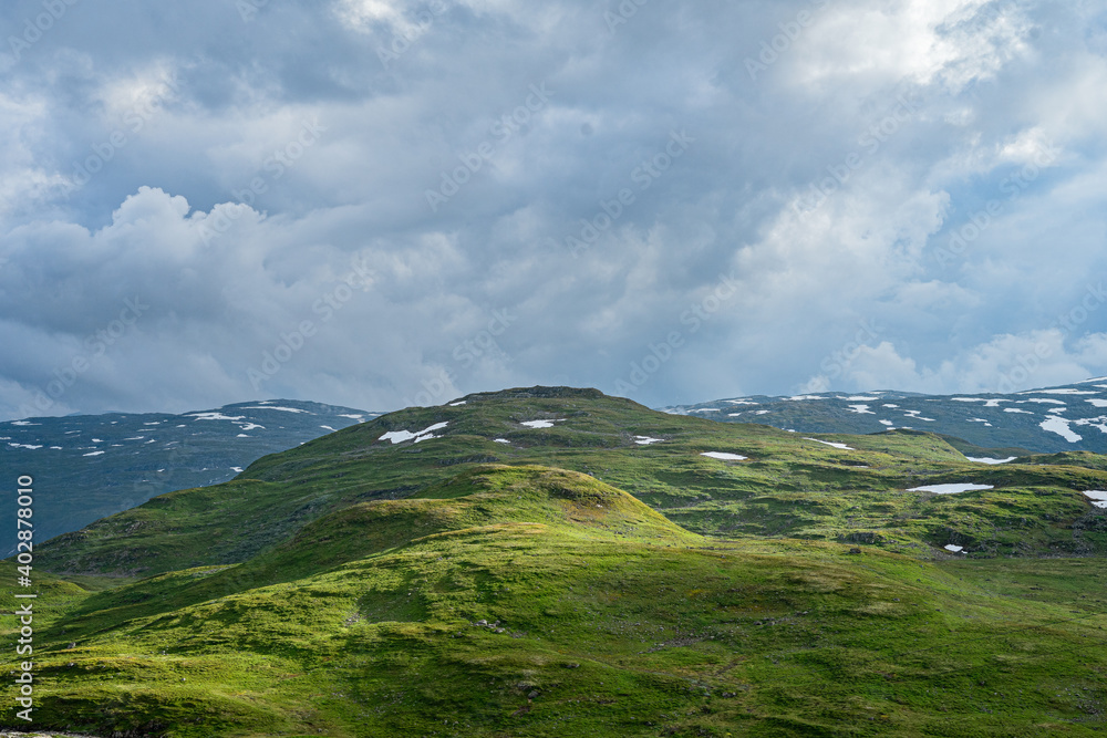 Fototapeta premium Norwegian landscape with snow fields and clouds