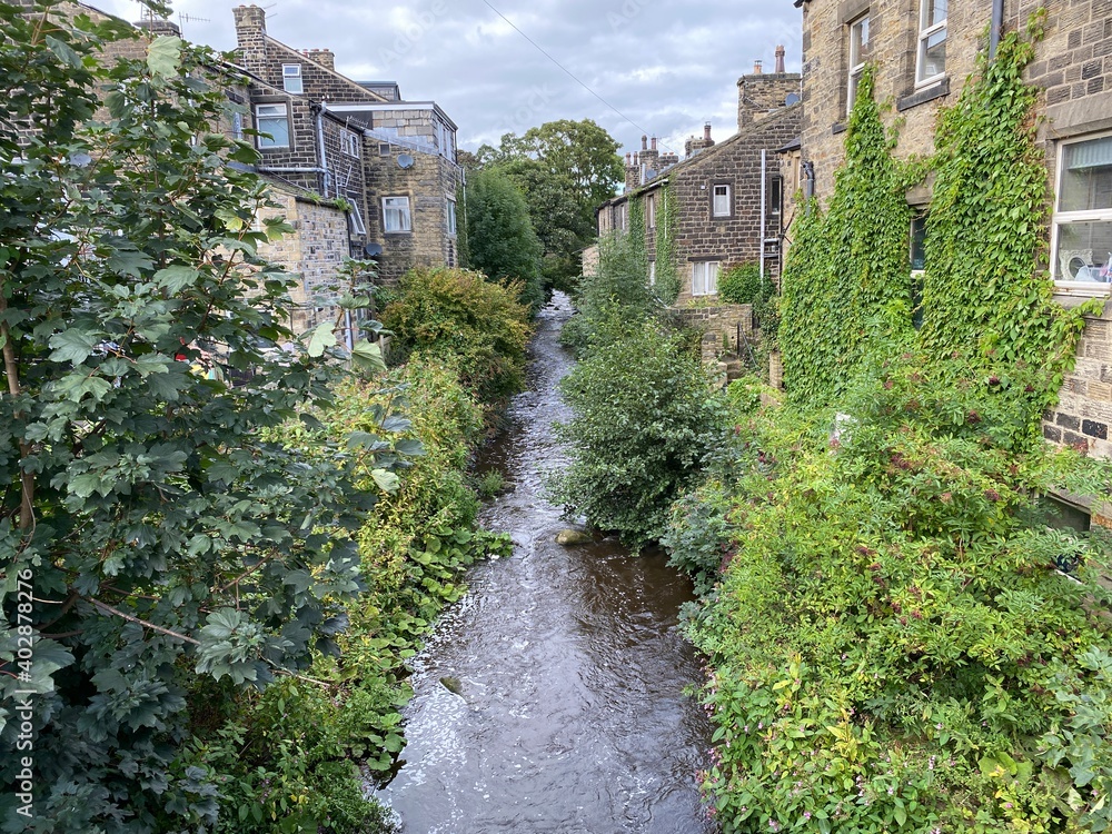 View of, Silsden Beck, as it flows between houses, in the centre of, Silsden, Keighley, UK View of, Silsden Beck, as it flows between houses, in the centre of, Silsden, Keighley, UK