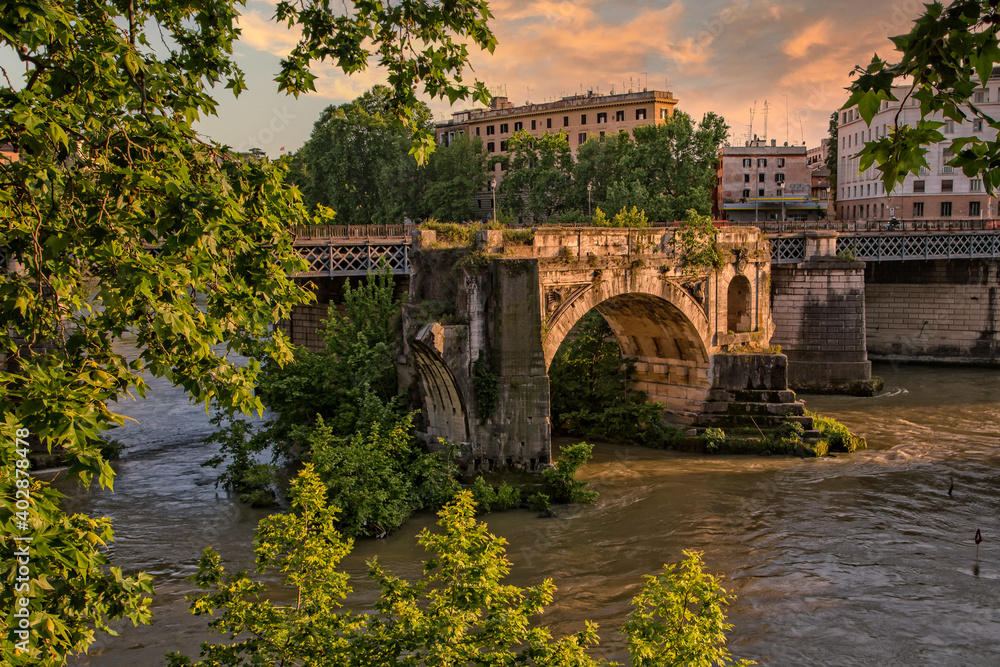 Amazing view of Tiber River and of the ancient Pons Aemilius in city of Rome. The remains of Pons Aemilius or Ponte Rotto, is the oldest Roman stone bridge in Rome, Italy