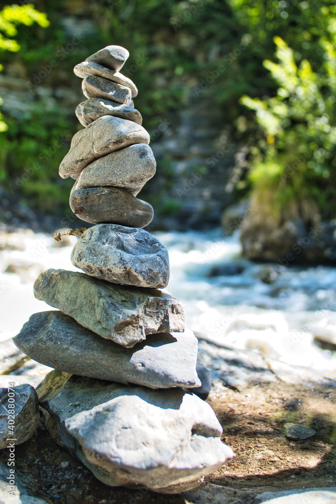 Stack of stones with river in bokeh background