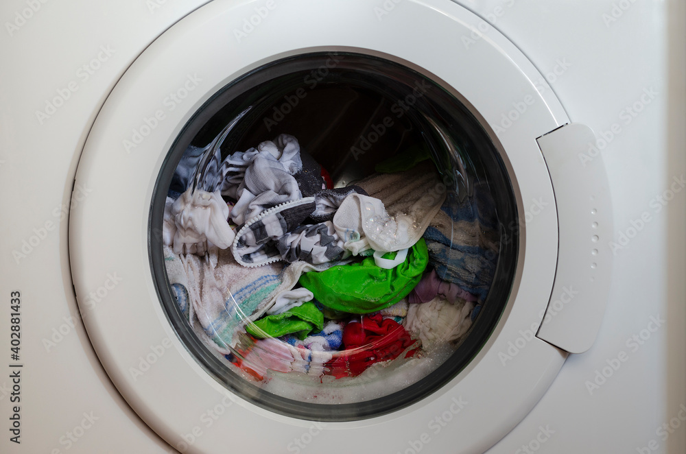 Washing machine door with rotating garments inside Washing machine door with rotating garments inside