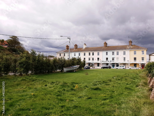 Canvas Print Dark sky over terraced houses in Bray town, Ireland.