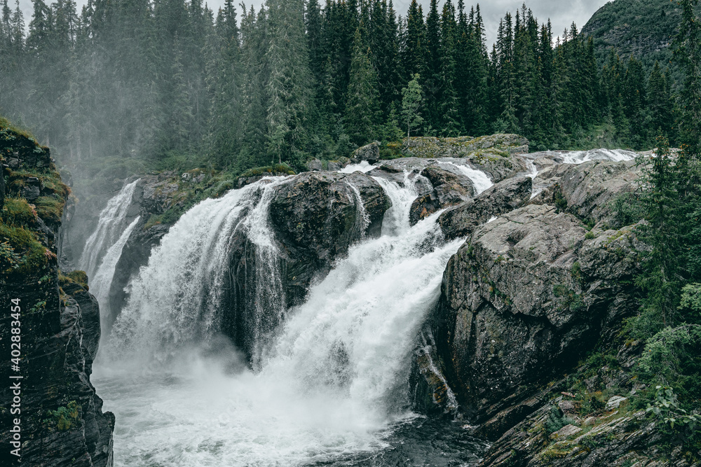 Fototapeta premium Rjukandefoss waterfall with dust and a rock
