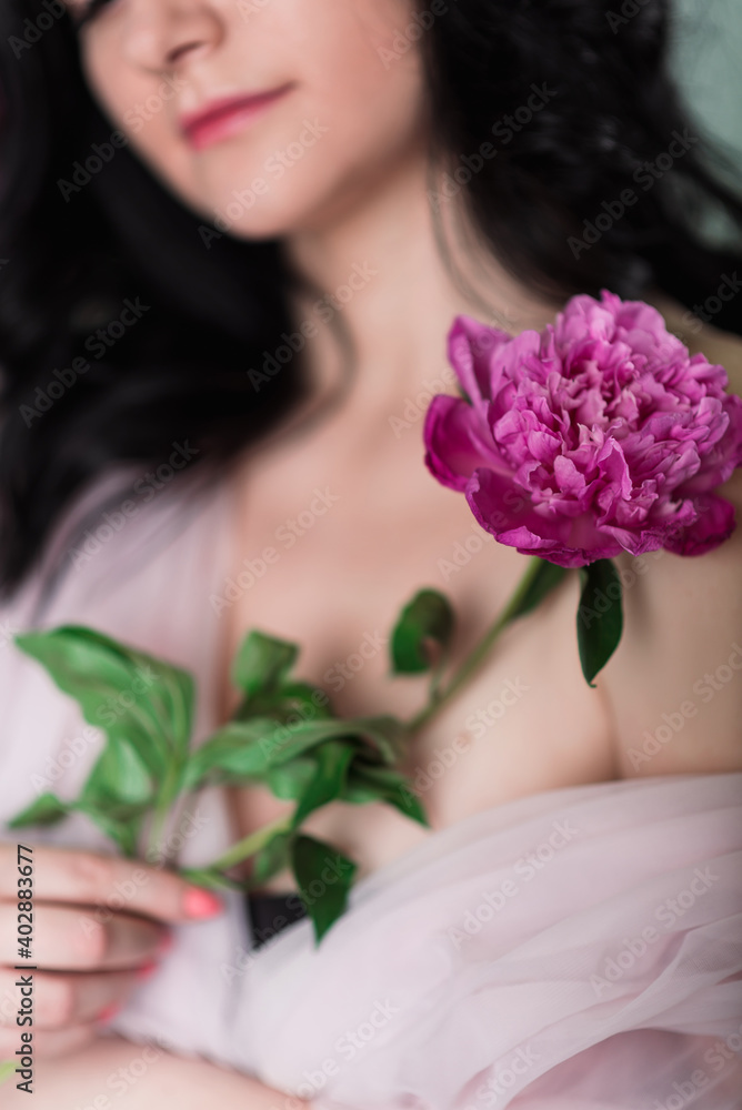 Indoor studio shot of sweet adorable young woman with white,pink and purple flowers in hands. Indoor studio shot of sweet adorable young woman with white,pink and purple flowers in hands.