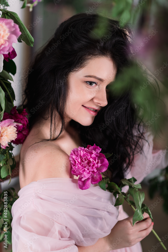 Indoor studio shot of sweet adorable young woman with white,pink and purple flowers in hands. Indoor studio shot of sweet adorable young woman with white,pink and purple flowers in hands.