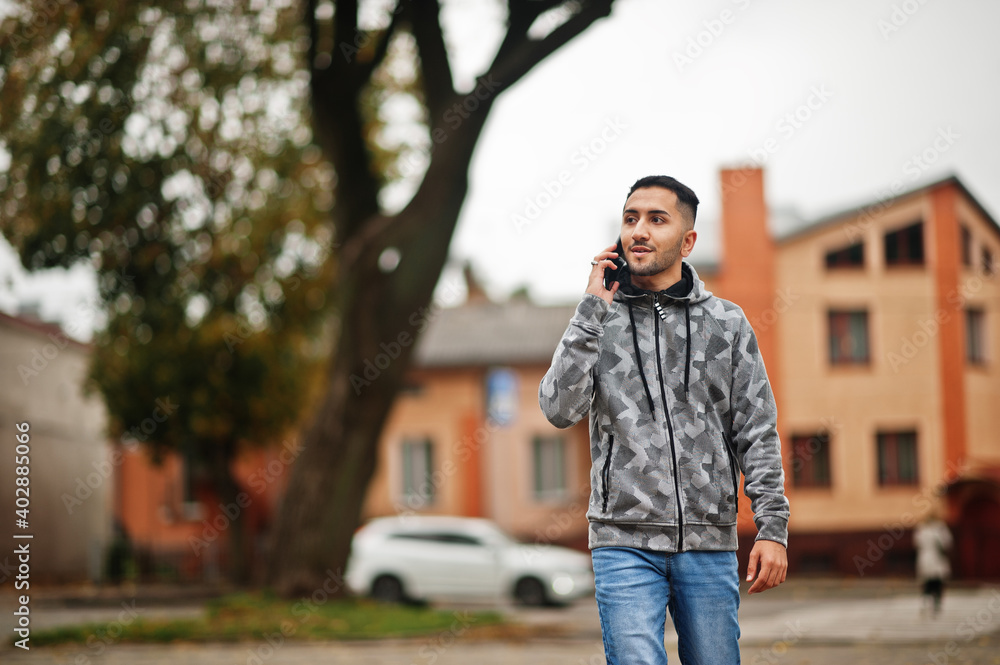 Student kuwaiti man wear at hoodie, speaking by phone. Student kuwaiti man wear at hoodie, speaking by phone.