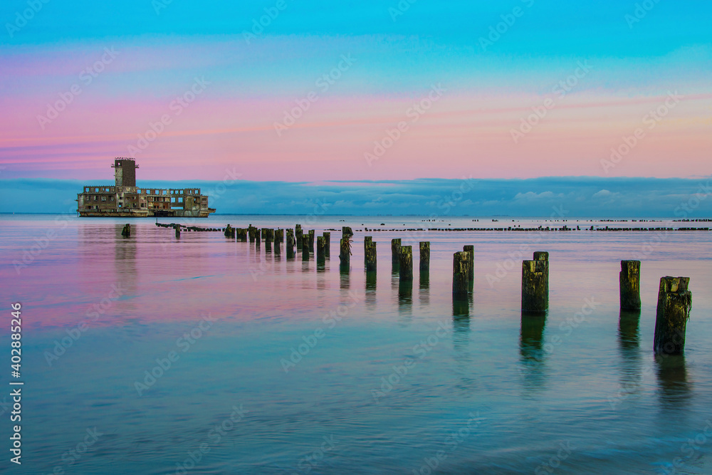 Obraz premium Torpedo station from the Second World War, Gdynia, Poland. Beautiful sunset on the Baltic Sea.