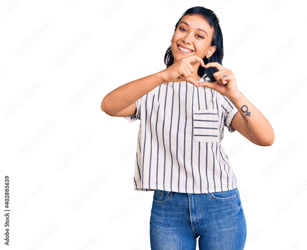 Young woman wearing casual clothes smiling in love doing heart symbol shape with hands. romantic concept.