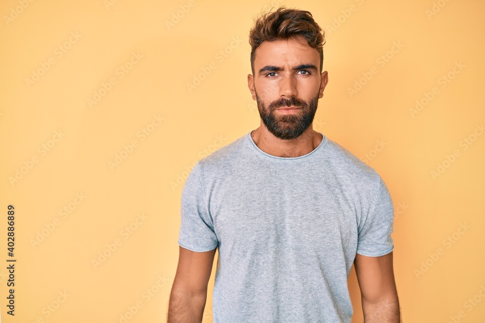 Obraz premium Young hispanic man wearing casual clothes with serious expression on face. simple and natural looking at the camera.