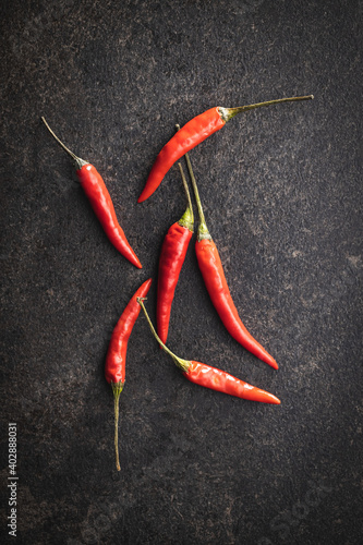 Red chili peppers on black table.