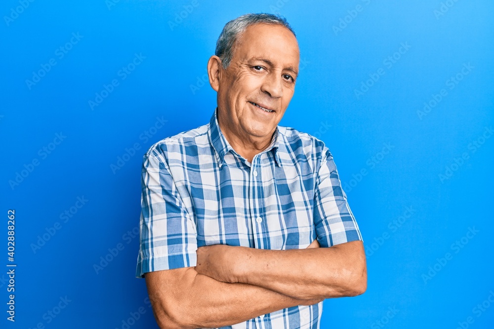 Senior hispanic man wearing casual clothes happy face smiling with crossed arms looking at the camera. positive person. Senior hispanic man wearing casual clothes happy face smiling with crossed arms looking at the camera. positive person.