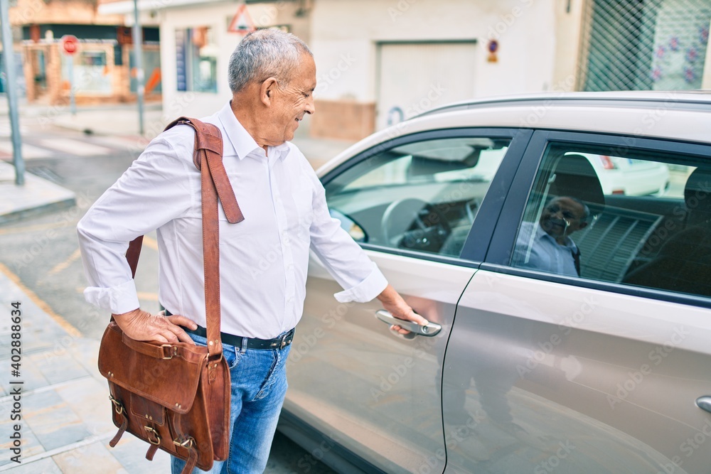 Senior man smiling happy opening car at the city. Senior man smiling happy opening car at the city.