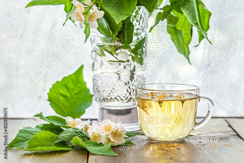 freshly brewed jasmine green tea on a wooden table near the window