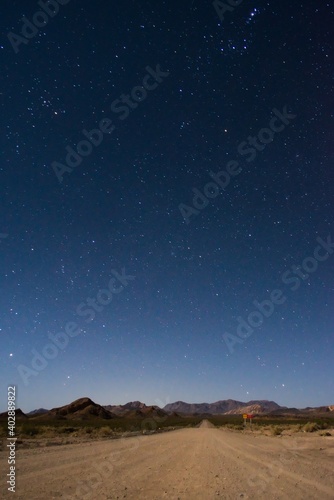 Starry night sky above a dirt road across the desert near Uspallata, Mendoza, Argentina.