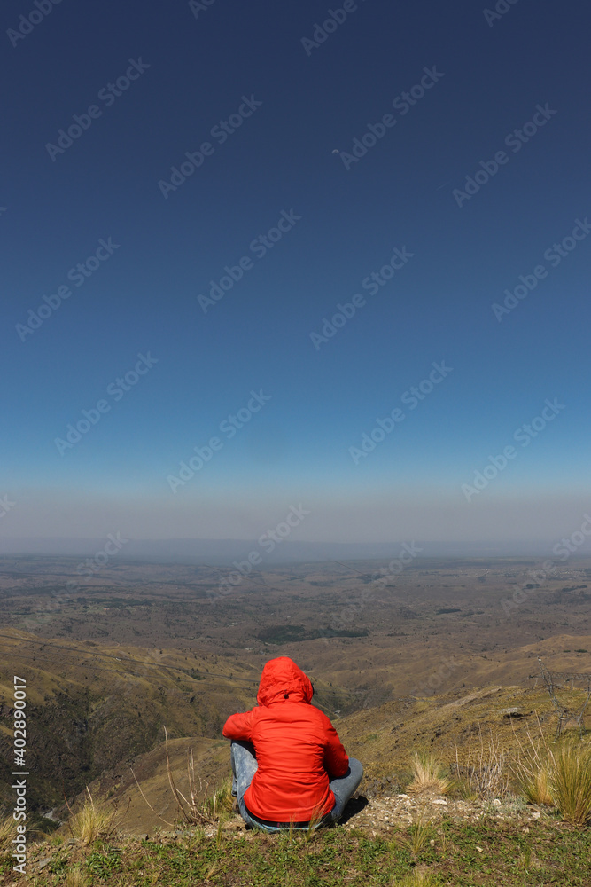 woman sitting on a mountain top peacefully - Cerro champaqui, cordoba, argentina woman sitting on a mountain top peacefully - Cerro champaqui, cordoba, argentina