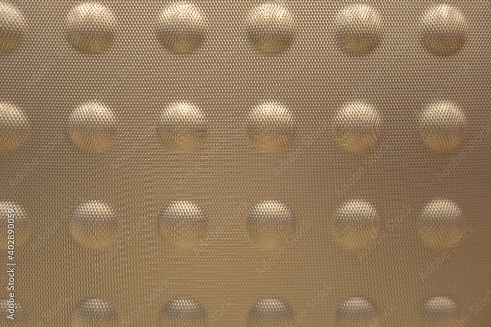abstract background of golden embossed plastic surface close up