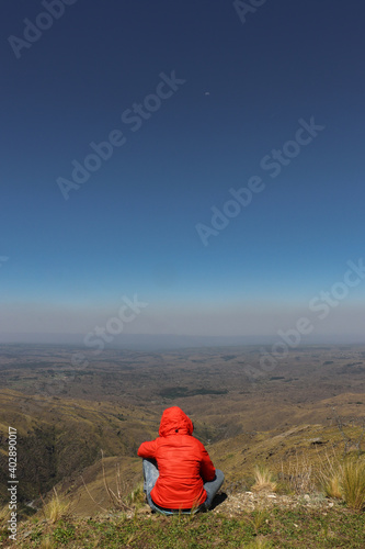 woman sitting on a mountain top peacefully - Cerro champaqui, cordoba, argentina photo