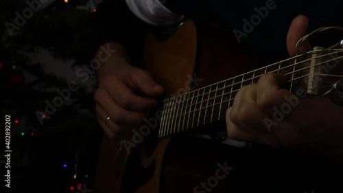 Young man playing acoustic guitar.
