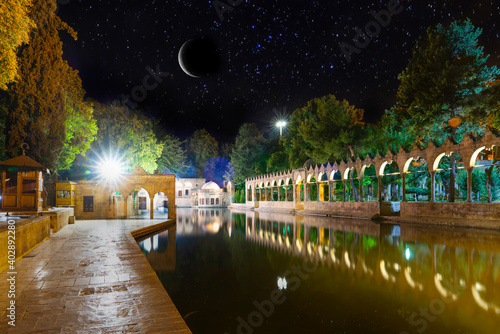 Sanli Urfa, Turkey: September 12 2020:  Halil-ur Rahman Mosque and Holy lake in Golbasi Park at night under crescent and stars photo