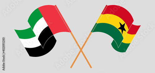 Crossed and waving flags of the United Arab Emirates and Ghana
