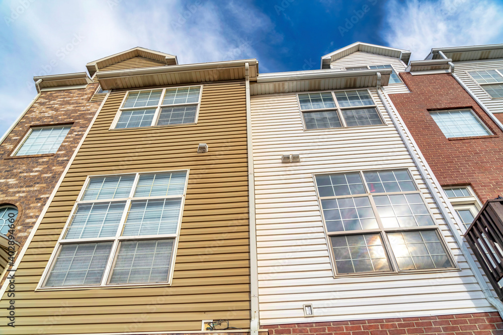 Exterior architectural details of townhouses with sidings and stone brick walls