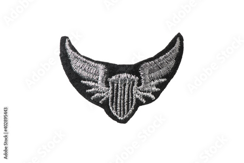 Shield with wings embroidered badge isolated on white background