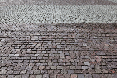 A stone-paved road. Stones on the ground. Perspective view