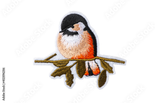 Bullfinch on a branch embroidered patch isolated on white background