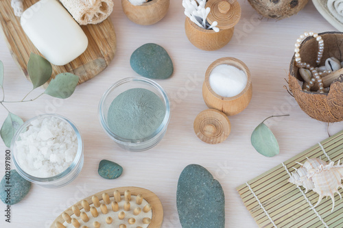 Beauty eco cosmetics zero waste, spa setting, composition with Dead sea salt, coconut, natural cosmetic blue clay, soda, loofah. Flat lay, Spa concept with cotton flower, stones and towel.