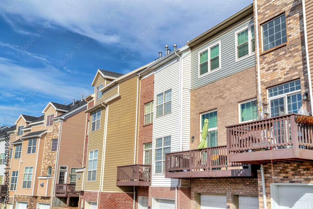 Exterior of townhouses with attached garages and stone brick and wall siding Exterior of townhouses with attached garages and stone brick and wall siding