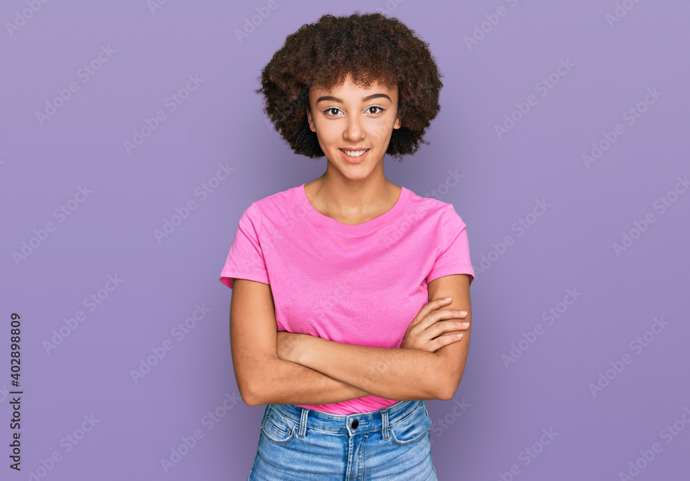 Young hispanic girl wearing casual clothes happy face smiling with crossed arms looking at the camera. positive person. Young hispanic girl wearing casual clothes happy face smiling with crossed arms looking at the camera. positive person.
