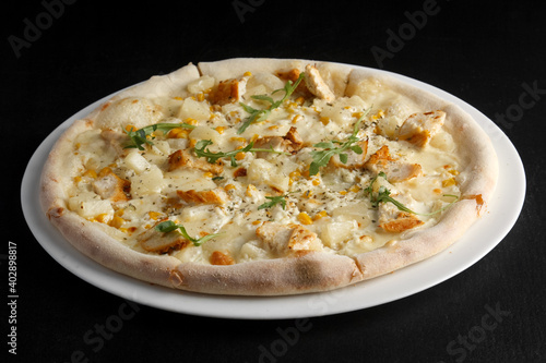 fragrant and hot pizza on a dark background
