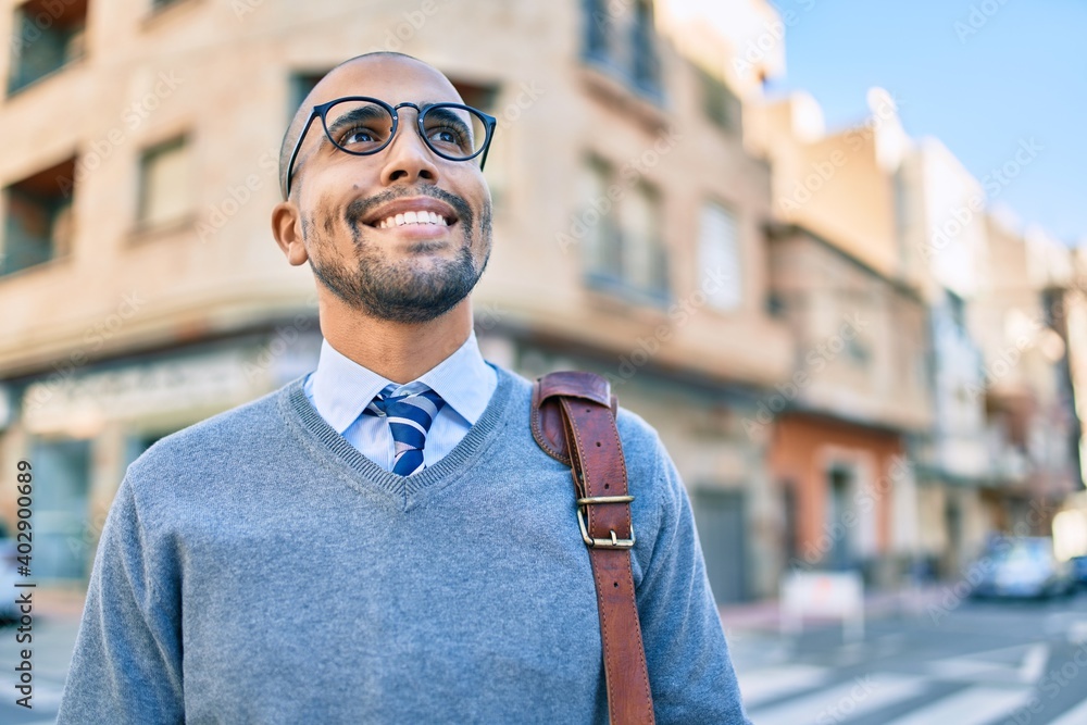 Young african american businessman smiling happy walking at the city. Young african american businessman smiling happy walking at the city.