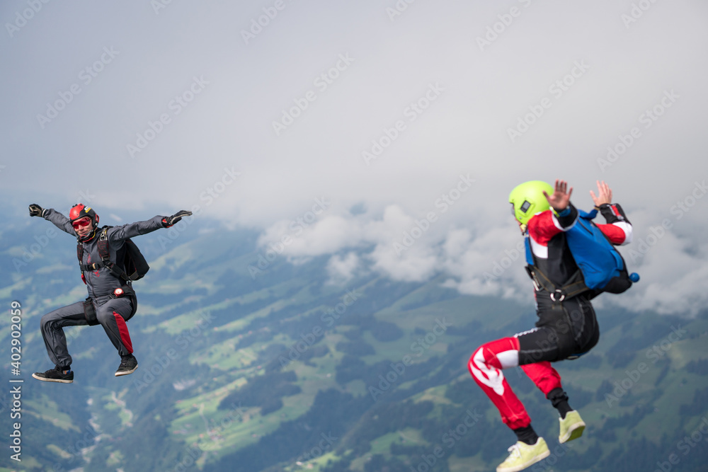 Team of skydivers perform acrobatics mid-air Team of skydivers perform acrobatics mid-air