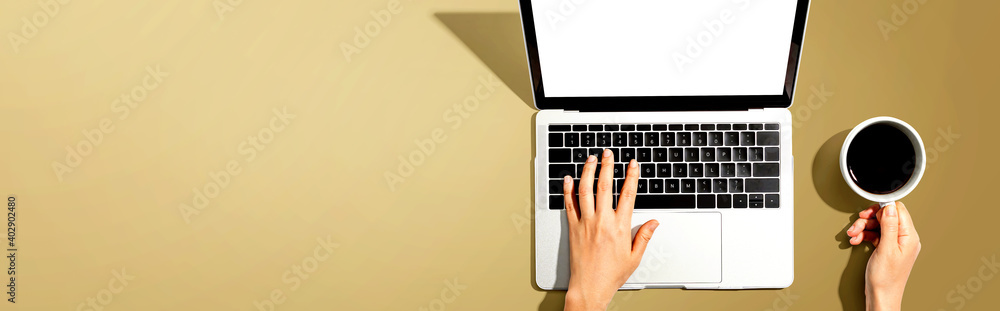 Person using a laptop computer from above Person using a laptop computer from above