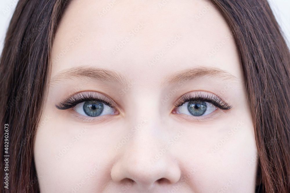 Eyelash extensions. Closeup of eyes with extended eyelashes and without extended eyelashes Eyelash extensions. Closeup of eyes with extended eyelashes and without extended eyelashes