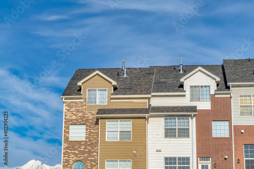 Townhouse with snowy peak of Wasatch Mountains and blue sky views in background
