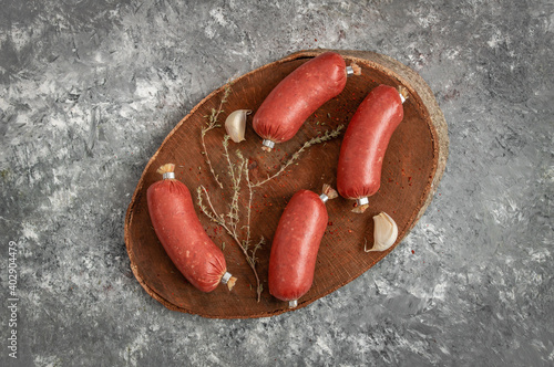 Turkish fermented sausage, dry spicy raw sausage on dark stone background