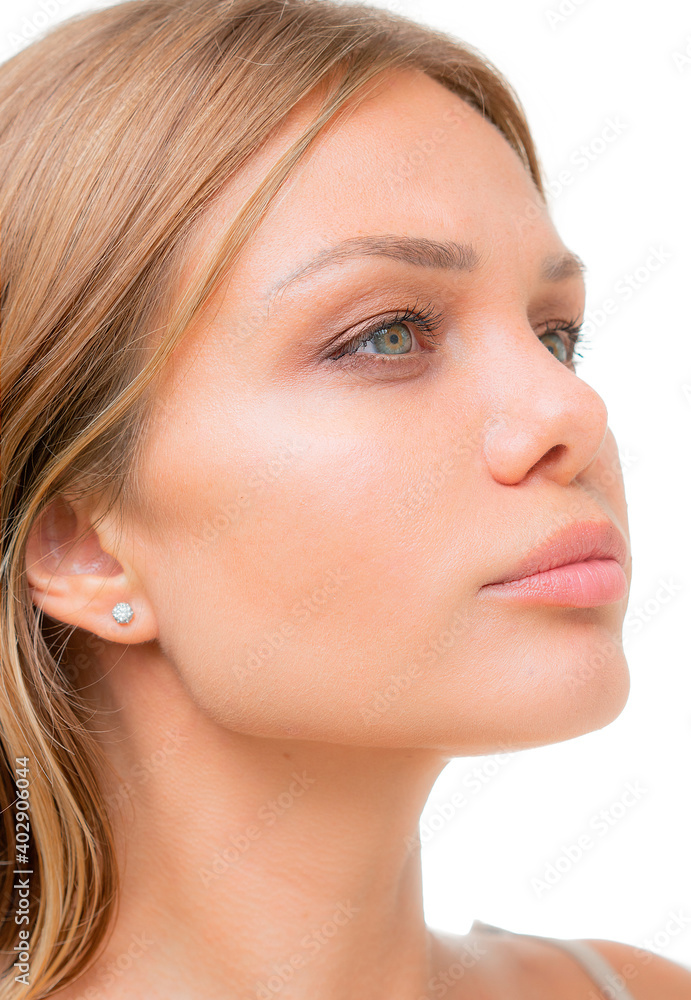 A confident young woman's portrait close up against white bakcground A confident young woman's portrait close up against white bakcground