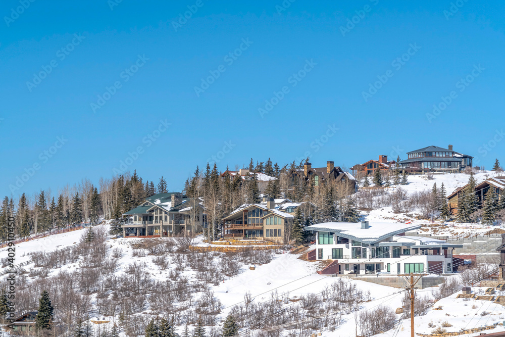 Park City community on a winter scene with houses on the snowy mountain slopes