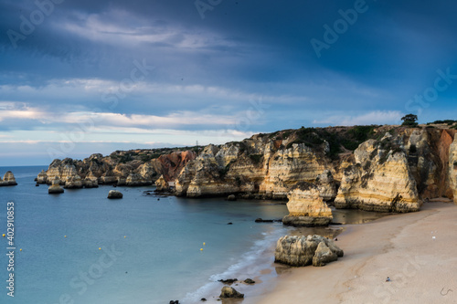 Early morning on the Algarve coast. Famous rocks and calm ocean. Dramatic sky. Lagos, Portugal