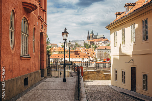 Prague Castle between buildings in a street of Prague, during wonderful sunny day with blue sky