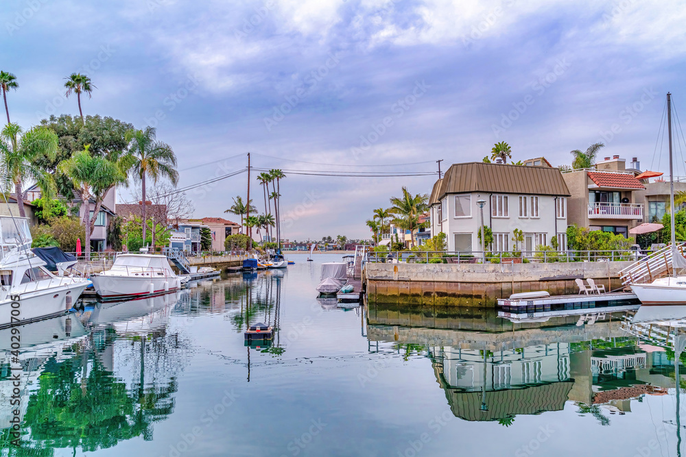 Boats and docks at a canal in scenic neigborhood of Long Beach California Boats and docks at a canal in scenic neigborhood of Long Beach California