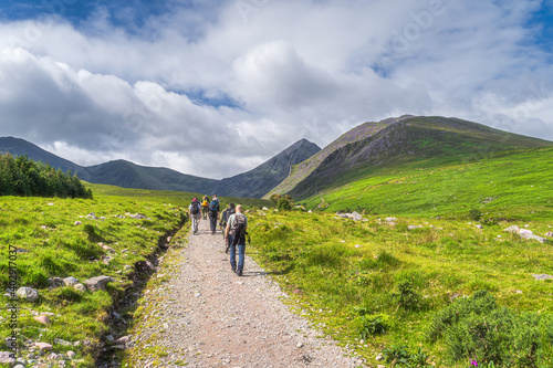 Obraz na płótnie Group of hikers in Cronins Yard on the trail to Devils Ladder to climb the highest mountain in Ireland Carrauntoohil, Ring of Kerry, Ireland w salonie