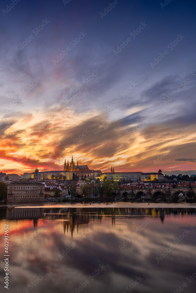 View on Charles Bridge and Prague Castle over Vltava River during early night with wonderful dusk sunset sky