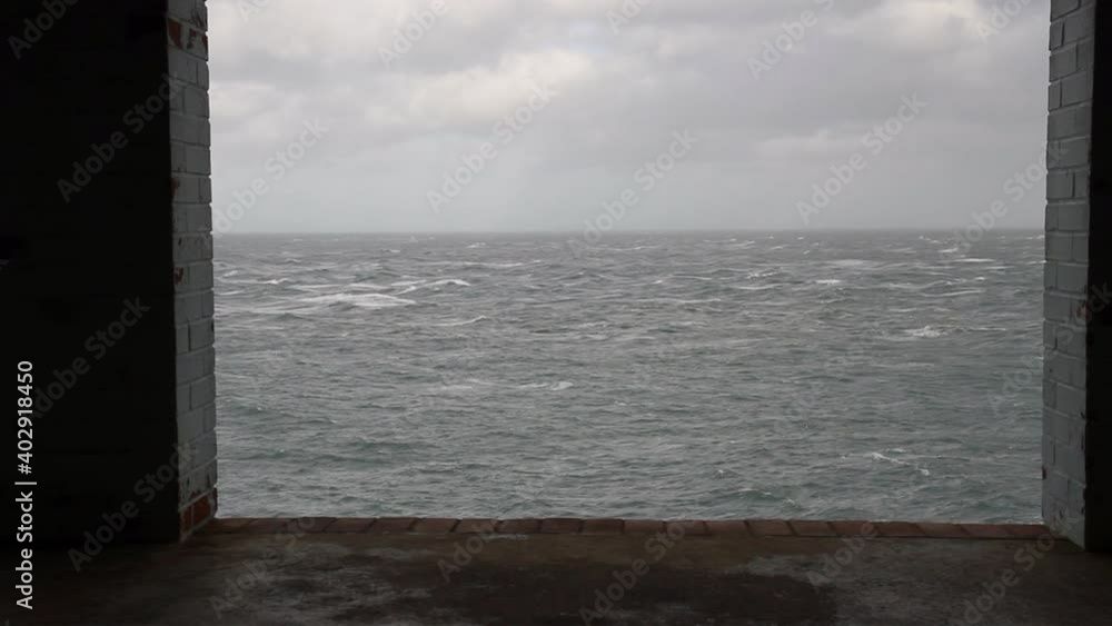 Stormy sea ocean framed in empty window of derelict building. Strumble Head, Wales, United Kingdom, landscape fully framed Stormy sea ocean framed in empty window of derelict building. Strumble Head, Wales, United Kingdom, landscape fully framed